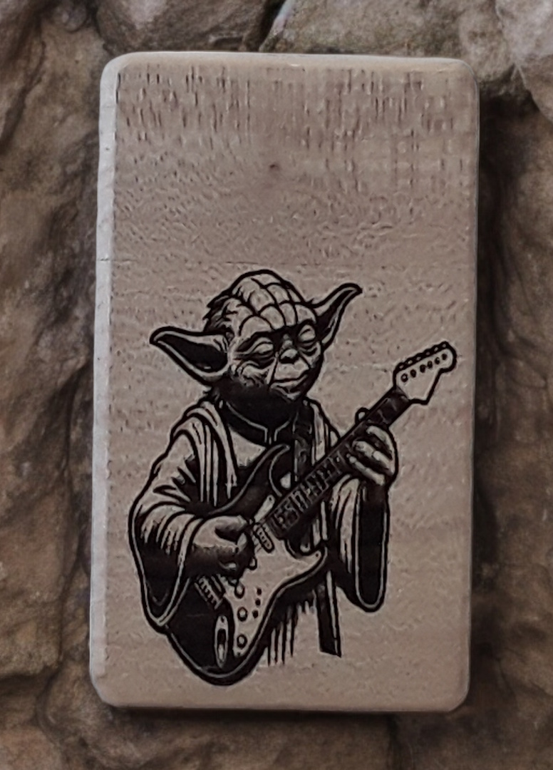 Image of a greenfoxx dugout Yoda playing guitar